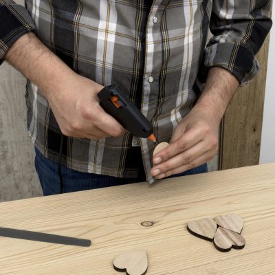 man-glueing-piece-wood